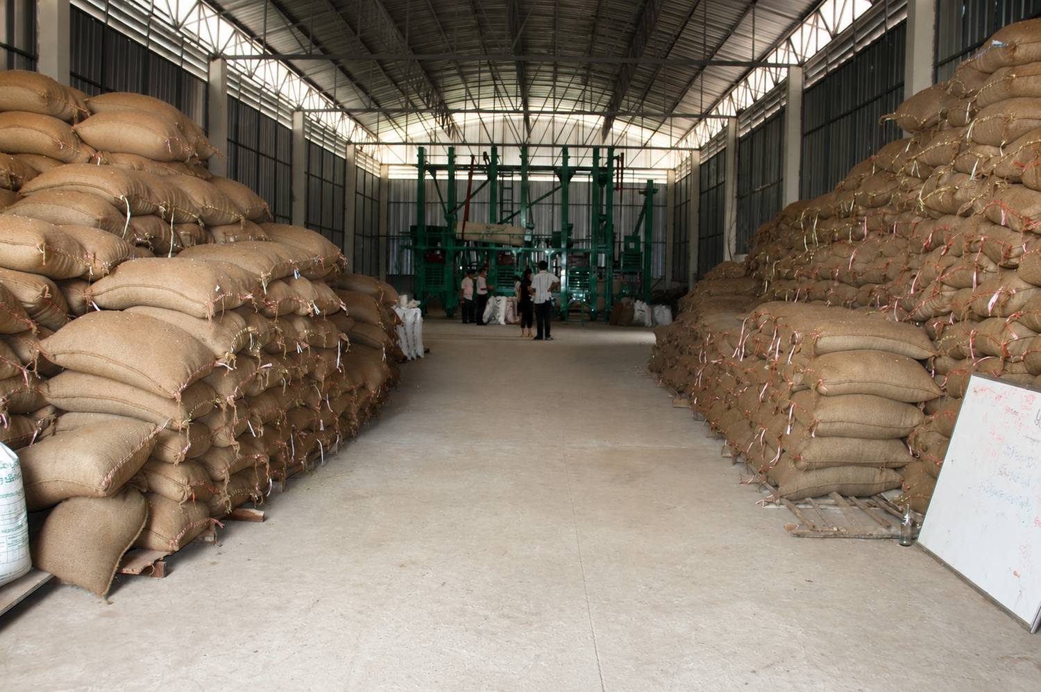 Interior of a Cressida AgroTrade warehouse stacked with bagged commodity ready for processing